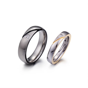 Matching steel couple rings featuring brushed silver and gold finish with single diamond