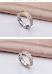 Detail of two-tone gold and silver brushed titanium steel rings with small inlaid diamonds