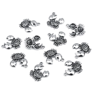 Macro view of antique silver crab pendants for DIY jewelry making and bracelet charms
