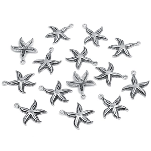 Flat lay of 15 silver starfish alloy pendants for DIY jewelry making on white background