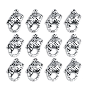 Macro detail of 12 silver fish-shaped metal lobster clasps with scale texture on white