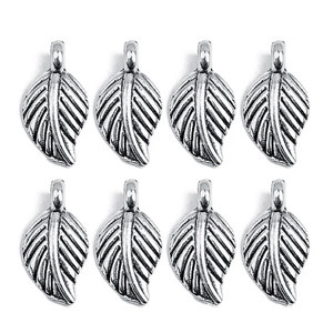 Detailed view of silver leaf-shaped alloy charms with intricate vein texture and rings