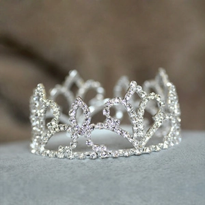 Detail of silver alloy crown hair claw with hollow patterns and sparkling crystals