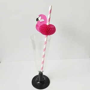 Pink flamingo honeycomb decoration on striped paper straw in a cocktail glass
