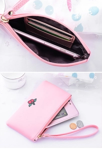 Detail view of pink cherry embroidery coin purse with card slots and wrist strap