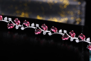 Macro shot of 18K white gold plated vine bracelet with red and white gemstones