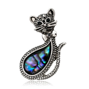 Detail of vintage silver cat brooch with black rhinestones and abalone shell inlay