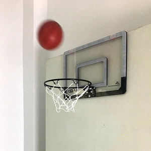 Wall-mounted mini basketball hoop with transparent acrylic backboard and flying ball