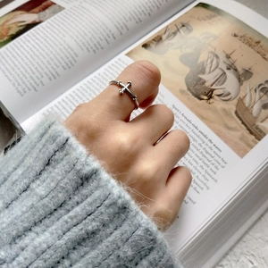 Close-up of S925 sterling silver vintage cross open ring with beaded edge and aged finish
