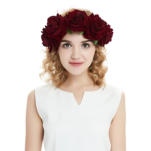 Detailed view of dual red velvet rose headband worn by a model on white background