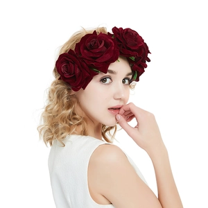 Detail shot of double deep red velvet roses hair clip worn on a model's head