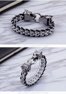 Detail view of double wolf head clasp and woven chain on punk stainless steel bracelet