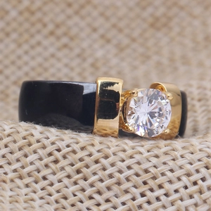 Macro shot of 6mm black ceramic ring with gold-plated prong-set round zirconia