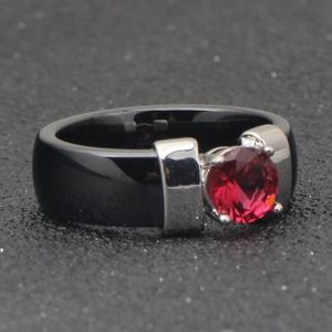 Detailed close-up of a 6mm black ceramic ring featuring a red crystal inlay setting