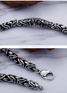 Macro detail of retro 316L stainless steel bracelet with skull relief and dragon lobster clasp