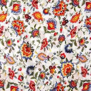 Detailed close-up of ethnic floral print on summer cotton linen shawl fabric