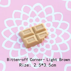 Macro shot of 2.5x3.5cm brown chocolate resin charm with realistic bite mark detail