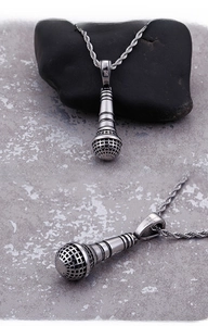 Detailed macro of 316L stainless steel microphone pendant with a twisted chain