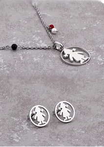 Close-up of silver steel jewelry set with girl silhouette and colorful beads