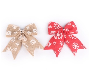 Close-up of red and natural burlap Christmas bows with white snowflake patterns