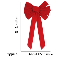 Detail view of red velvet Christmas bow ornament with dimensions 49cm by 26cm
