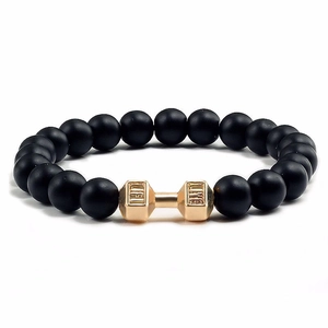 Men's matte black beaded stretch bracelet featuring a gold engraved dumbbell charm
