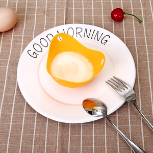 Yellow food-grade silicone egg poacher with a boiled egg inside, top view perspective