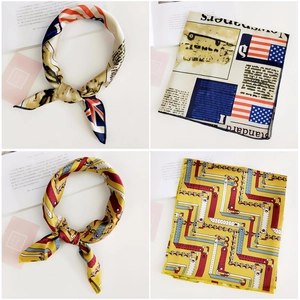 Detail of silk-feel square scarves featuring flag and geometric prints on white background
