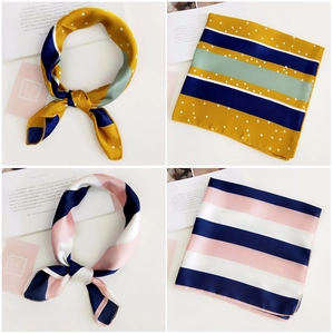Detailed views of striped silk-feel square scarves in yellow and pink striped patterns