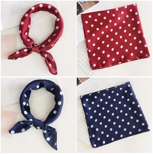 Close-up of red and navy blue polka dot satin square scarves in a grid layout