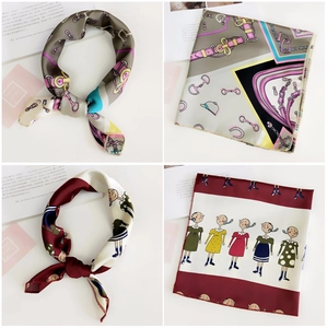 Close-up of printed silk square scarves featuring equestrian motifs and cartoon patterns