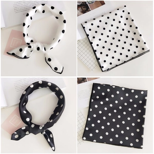 Close-up of elegant polka dot silk scarves in black and white styles for neck decoration