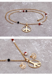 Detailed macro view of gold-toned peace sign necklace and earring set with tricolor beads