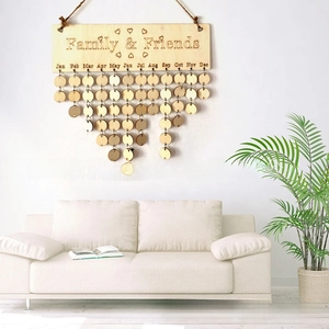 Close-up of wooden family and friends birthday calendar hanging on a white wall