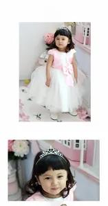 Detailed view of pink princess dress with lace trim and heart rhinestone tiara