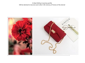 Detail of red V-quilted matte crossbody bag with gold chain strap and metal lock closure
