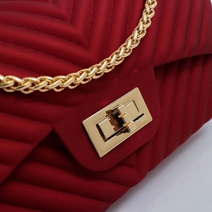 Matte dark red crossbody bag with V-shaped quilting and gold metal chain strap