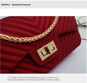 Detail of dark red V-quilted jelly bag featuring golden chain and metal twist lock closure