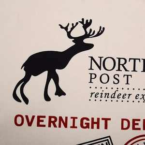 Macro shot of reindeer print and North Post text on Christmas canvas gift bag fabric