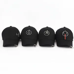 Four black cotton baseball caps with metal ring accents and assorted fashion charms