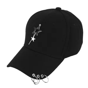 Close-up of black baseball cap featuring silver metal stars and triple rings on brim