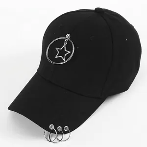 Detail of black cotton baseball cap with punk star pendants and metal ring accents