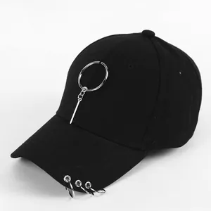 Detail of black cotton baseball cap featuring silver rings and metal hanging ornaments