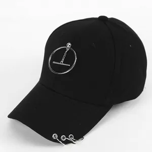 Detail of black cotton baseball cap with silver metal rings and hanging chain accessory