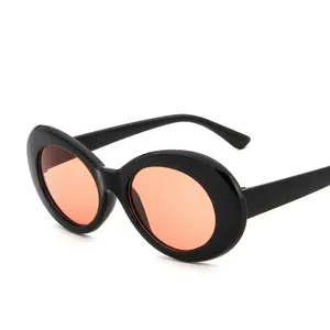 Fashionable oval sunglasses with glossy black frames and vintage orange lenses on white