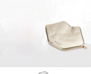 Close-up of golden PU leather coin purse with litchi texture and metal zipper
