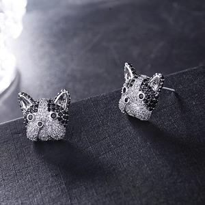 Detailed macro view of silver French Bulldog stud earrings with micro-pave crystals
