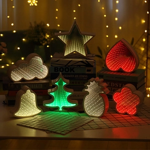 Variety of LED infinity mirror lights in star, heart, and cloud shapes on a cozy desk