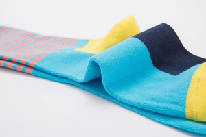 Detailed view of colorful cotton knitted socks with pink stripes and vibrant yellow accents