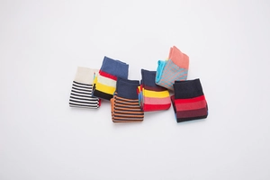 Flat lay of five pairs of colorful striped cotton crew socks for men and women